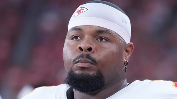 Chiefs tackle Jawaan Taylor looks on without a helmet during a game.
